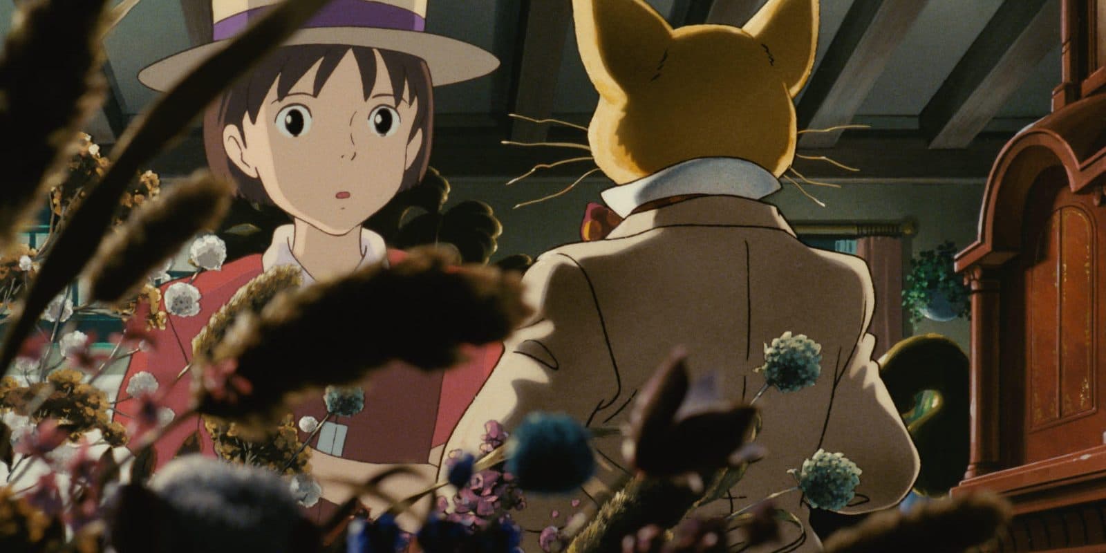 still from Whisper of the Heart: Shizuku looking at the cat figurine of the Baron in the antique shop