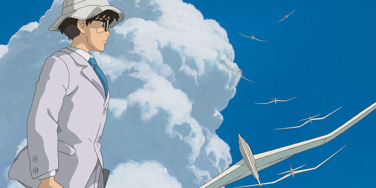 still from The Wind Rises: Jiro watching paper gliders float up into a summer sky
